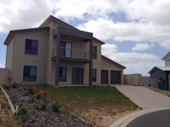 a large house with a driveway in front of it at Relax On Par in Port Hughes