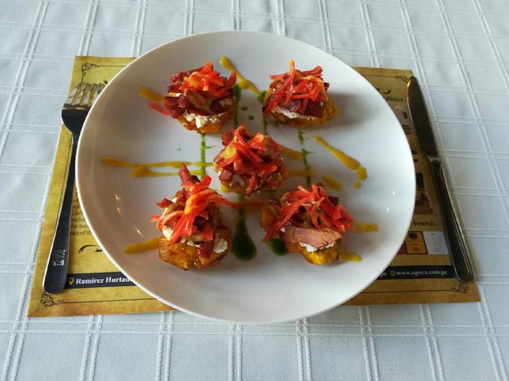 a white plate of food on a table at Epoca Iquitos in Iquitos