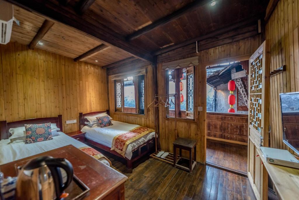 Postel nebo postele na pokoji v ubytování Huangshan Xidi Shang De Tang