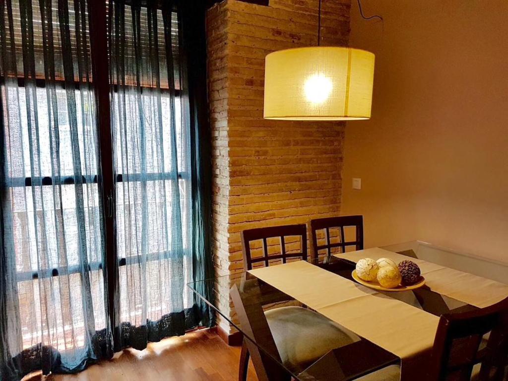 バレンシアにあるGuillem Sorolla Apartmentのダイニングルーム(テーブル、椅子、窓付)
