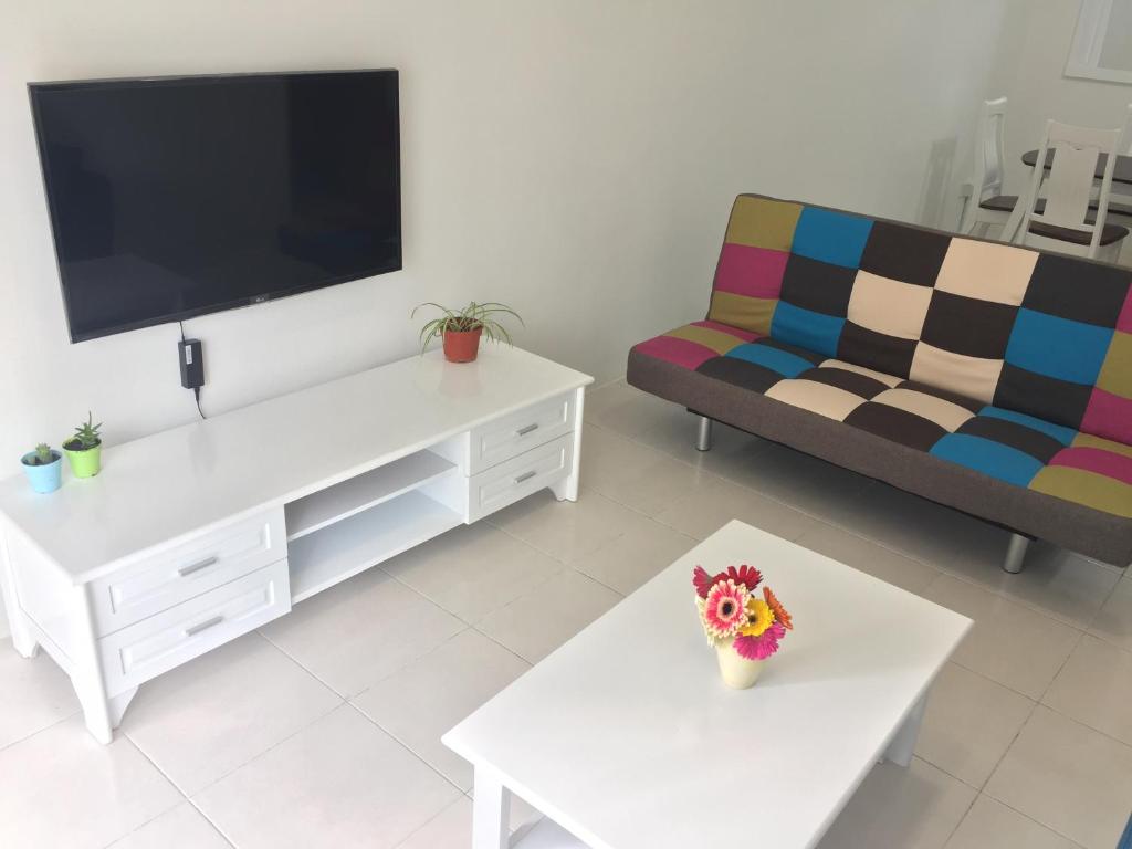 a living room with a tv and a couch at Cameron Prima Apartment @ Cameron Jaya in Cameron Highlands