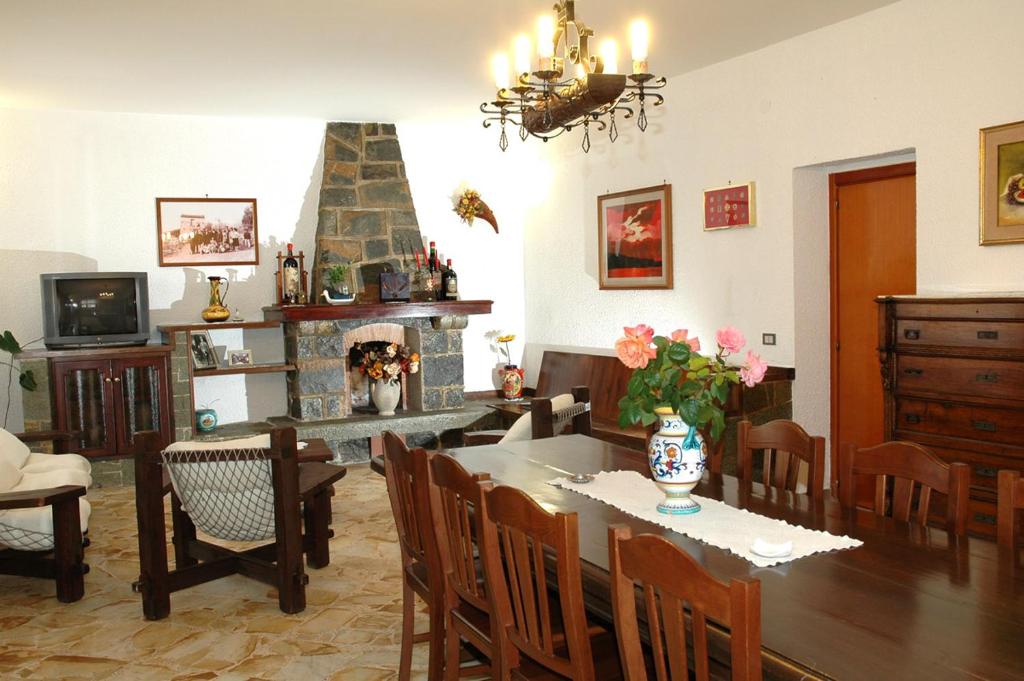 a dining room with a table and a fireplace at B&B La Porta Del Cilento in Capaccio-Paestum