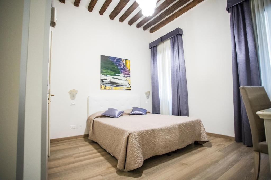 Postel nebo postele na pokoji v ubytování Locanda Ca' Lucrezia