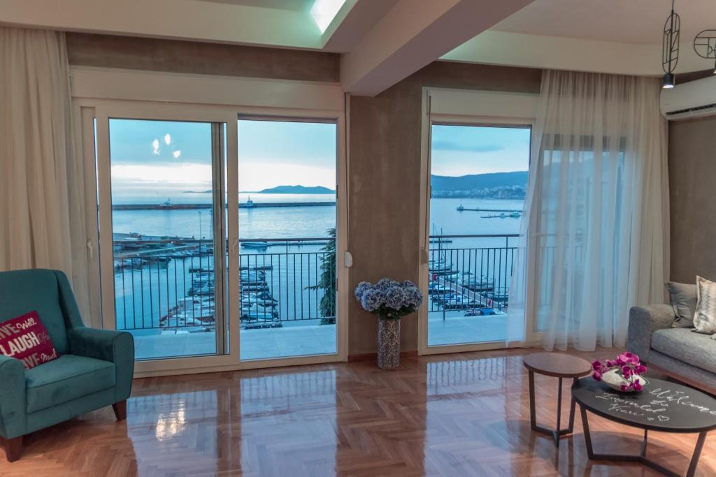 a living room with a view of the water at Jetties & Moorings central apt in Kavala