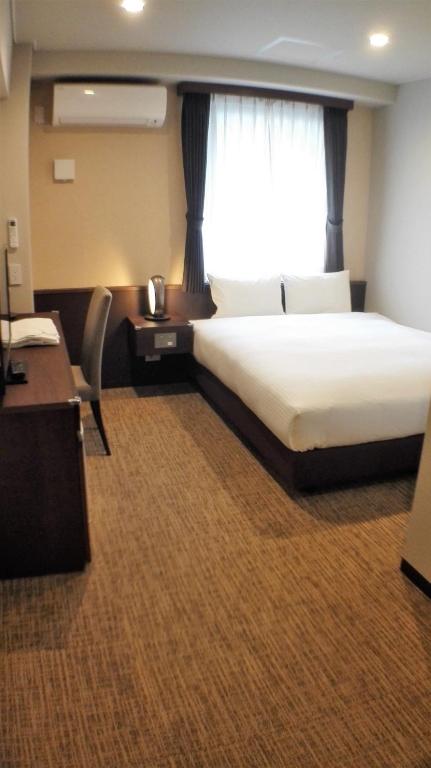 Postel nebo postele na pokoji v ubytování Bande Hotel Osaka
