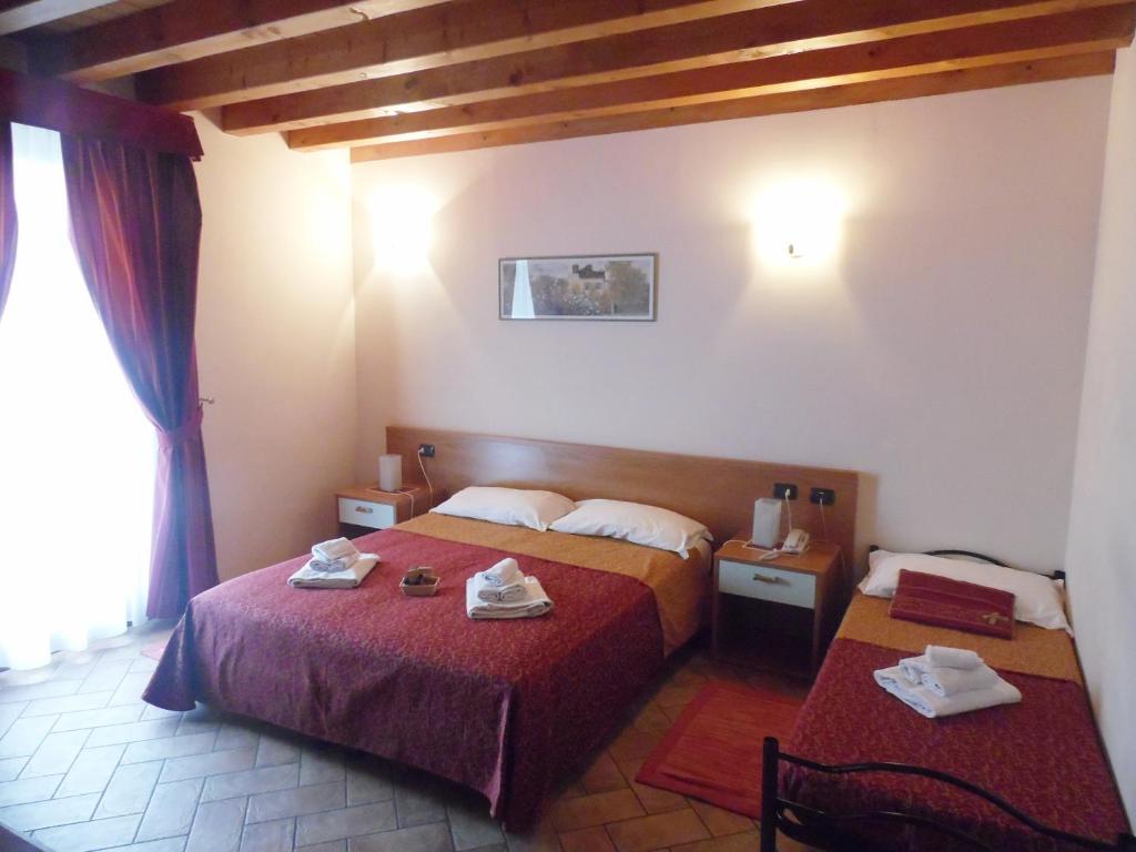 Postel nebo postele na pokoji v ubytování Hotel Agli Ulivi
