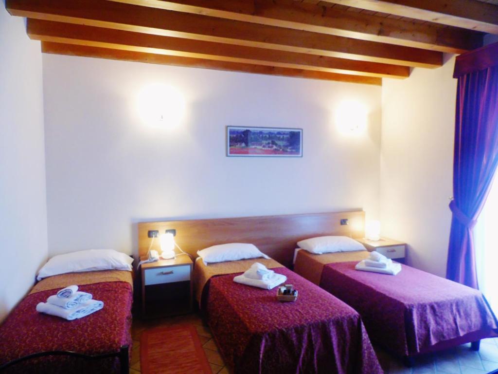 Postel nebo postele na pokoji v ubytování Hotel Agli Ulivi