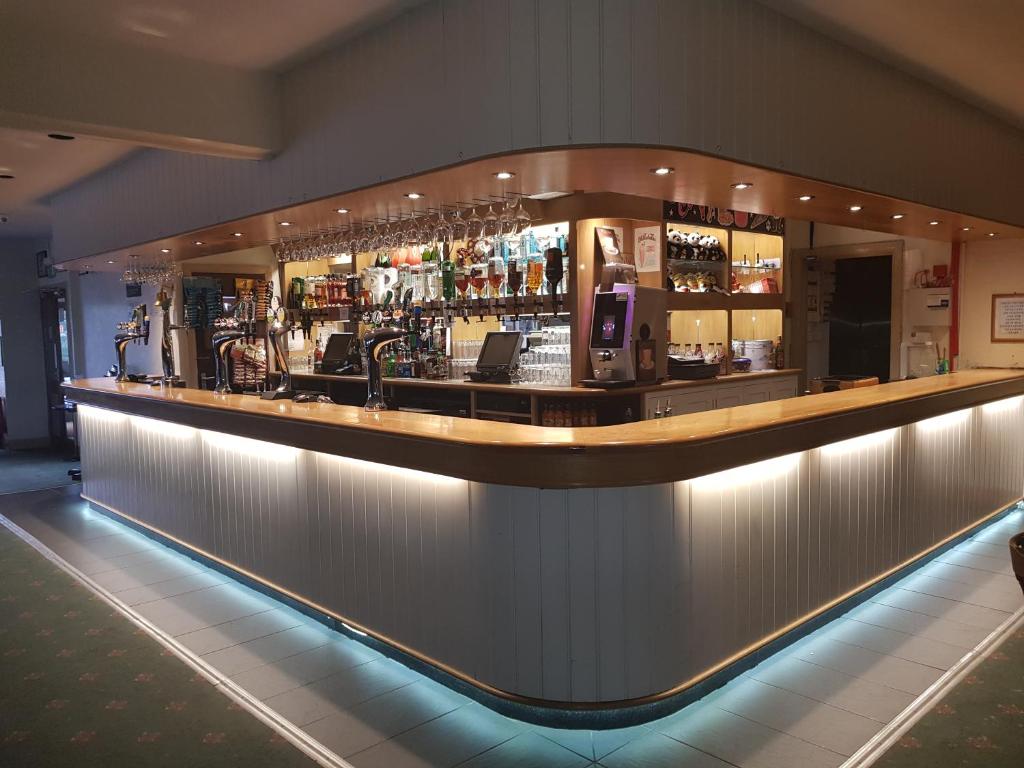 a bar with a long counter with drinks at Sunnyvale Holiday Park in Saundersfoot