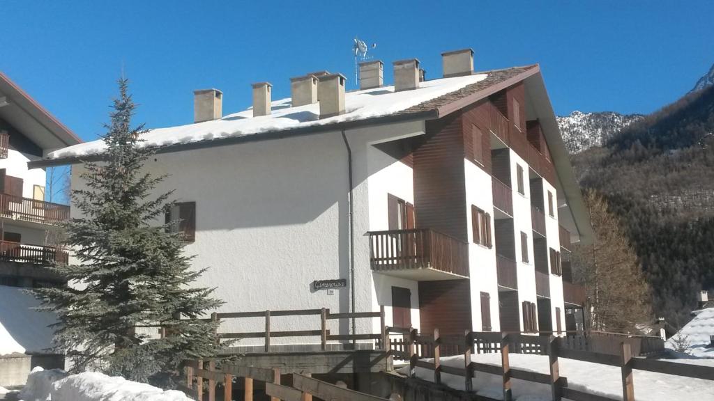 a large building with snow on the ground at Genevris in Pragelato