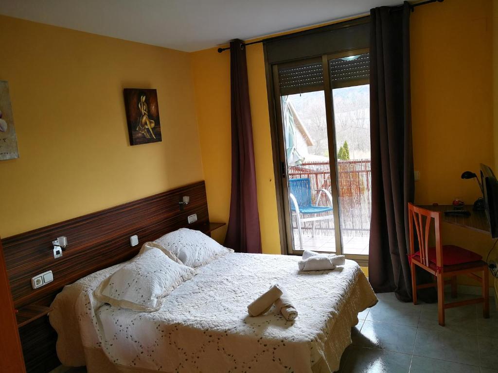 Postel nebo postele na pokoji v ubytování Hostal Escarla