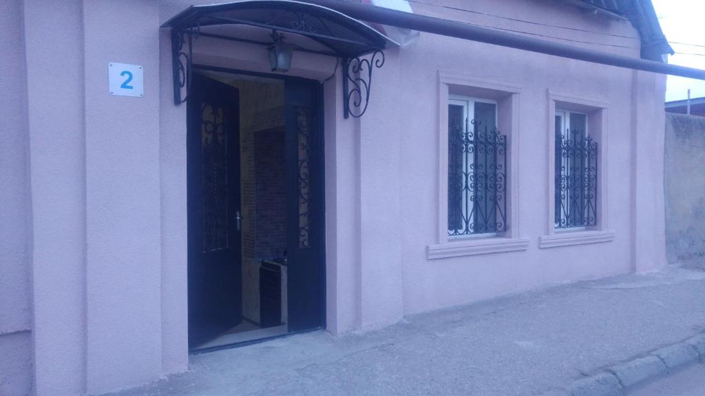 a building with a door with a sign on it at Apartments on Akhalubani St 2 in Tbilisi City