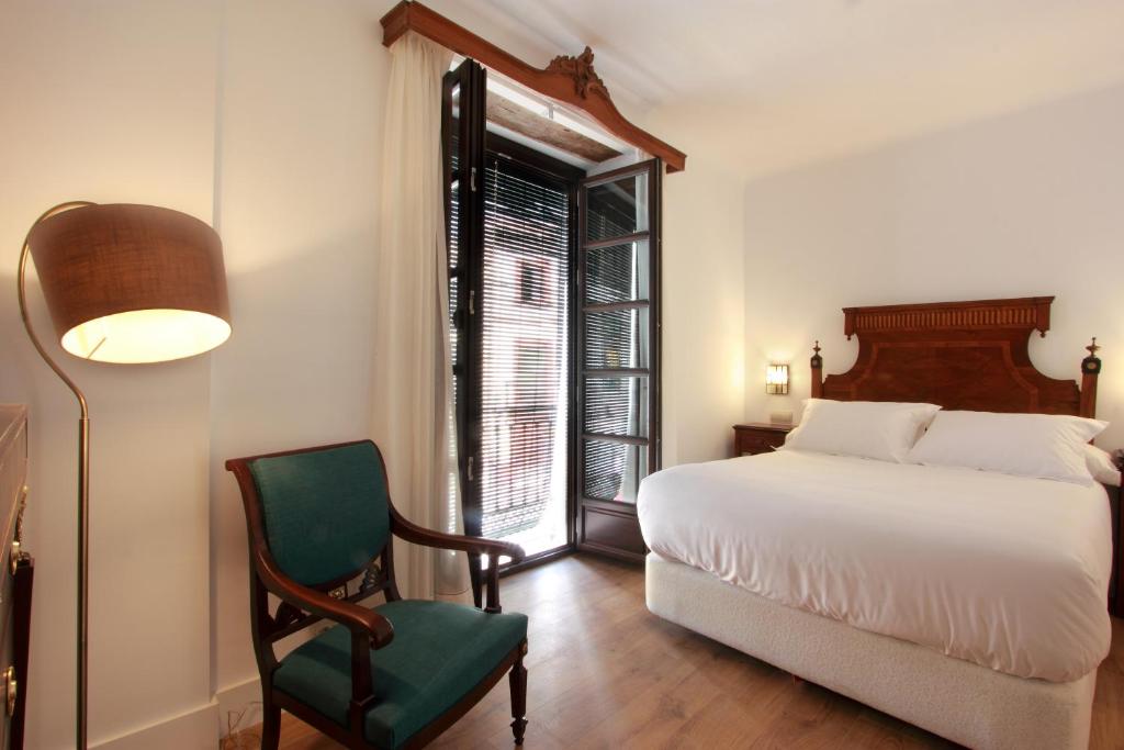 Hotel Patria Chica tesisinde bir odada yatak veya yataklar