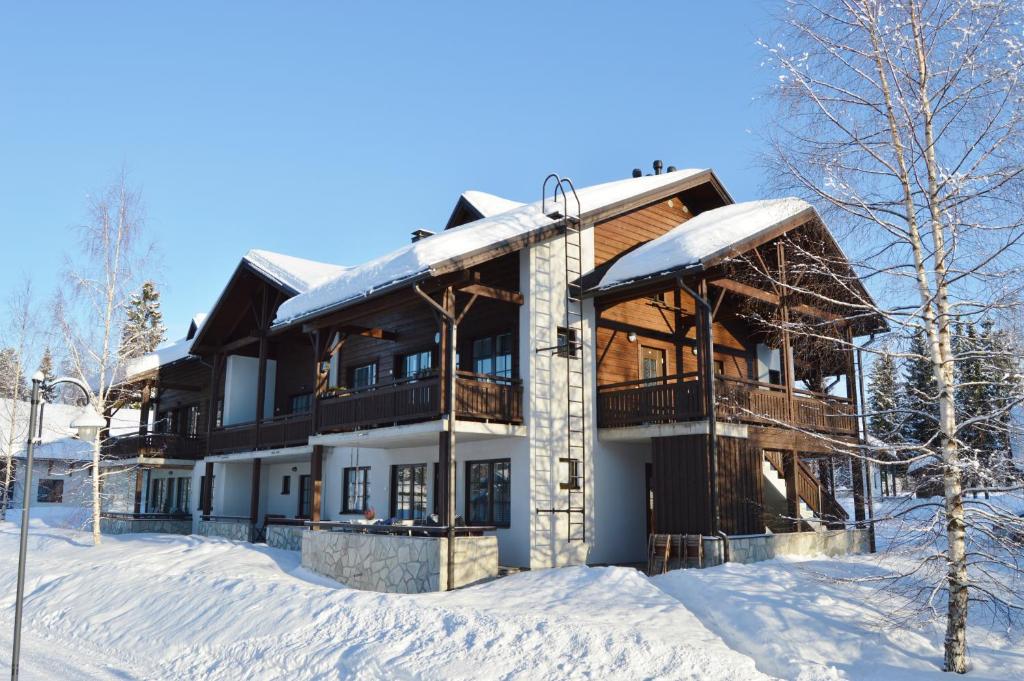 a large house in the snow with snow at Pointin Vale Apartment Tahko in Tahkovuori