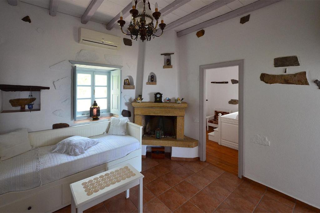 a living room with a couch and a fireplace at Patmos Chora traditional villa Genadio in Patmos