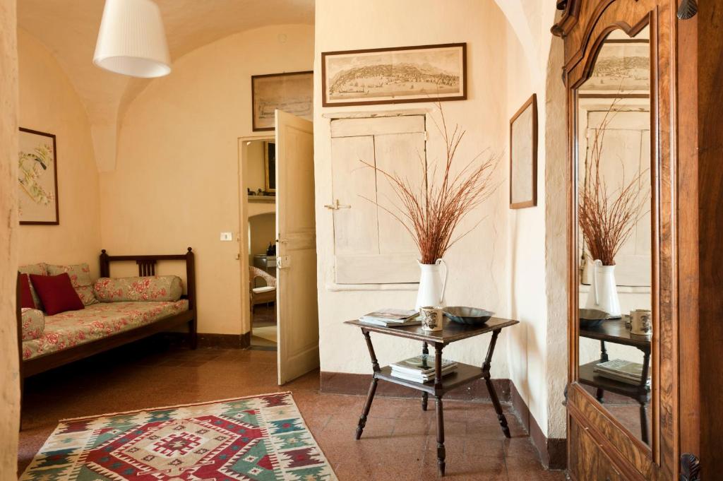 a living room with a couch and a table at Castello di Rocca Grimalda in Rocca Grimalda