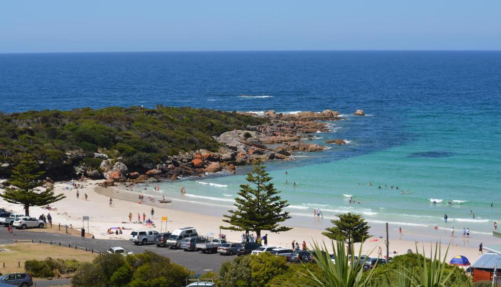 a group of people on a beach near the ocean at Seascape Beach House in Boat Harbour