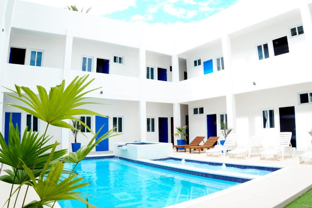 an apartment with a swimming pool in a building at Burí Hotel in Monterrico