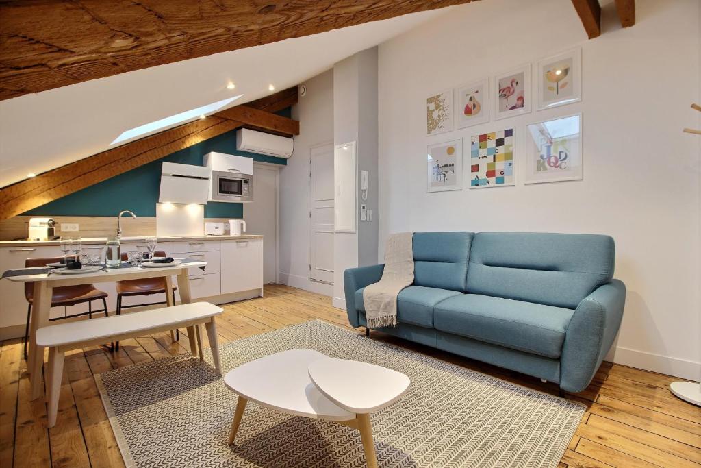 トゥールーズにあるAppartements Design Hypercentreのリビングルーム(青いソファ付)、キッチン