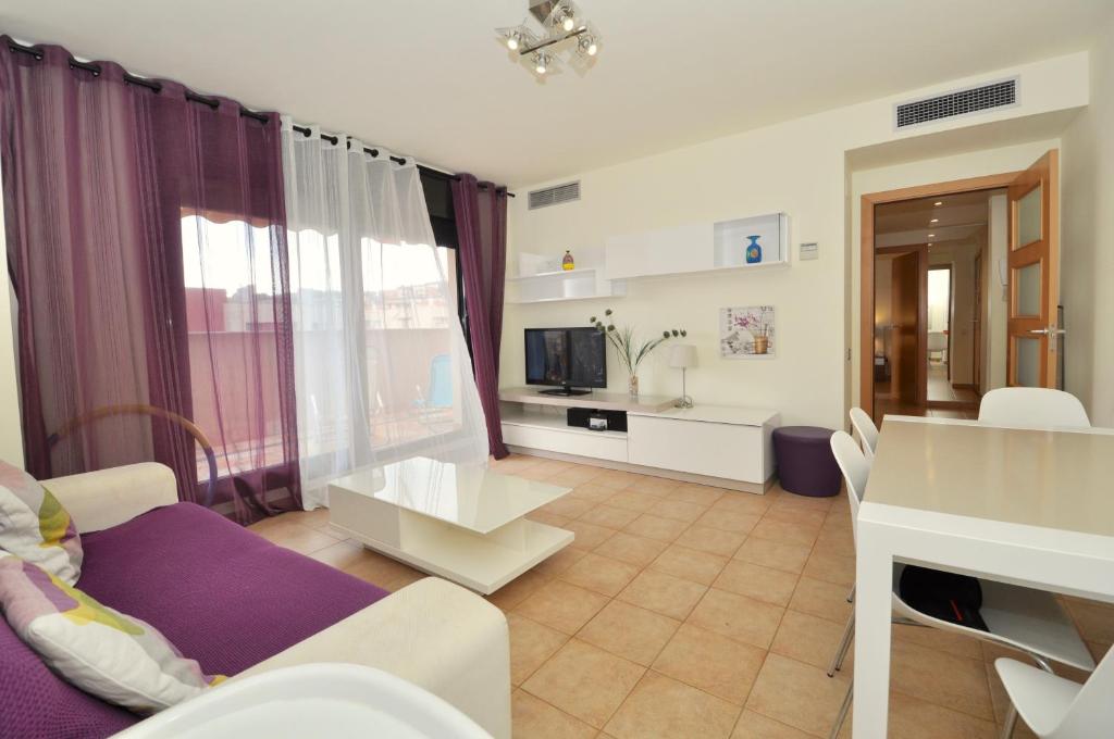 a living room with a couch and a table at Apartment Arigata in Lloret de Mar