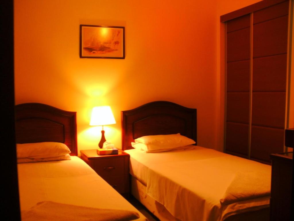 Postel nebo postele na pokoji v ubytování Al Rashid Hotel