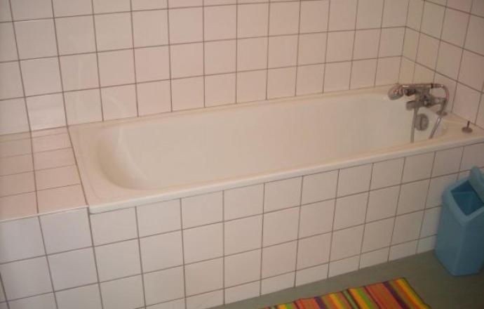 a bath tub with a faucet in a bathroom at Gîte de la Grande Fontaine in Isches