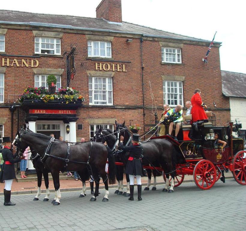 a horse drawn carriage on a city street at The Hand Hotel in Chirk