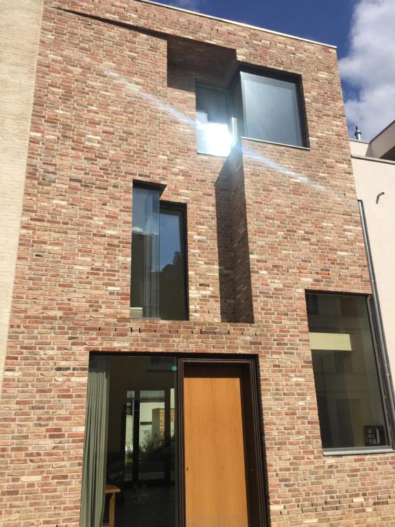 a brick building with a brown door and windows at An der Mauer 15 in Lübeck