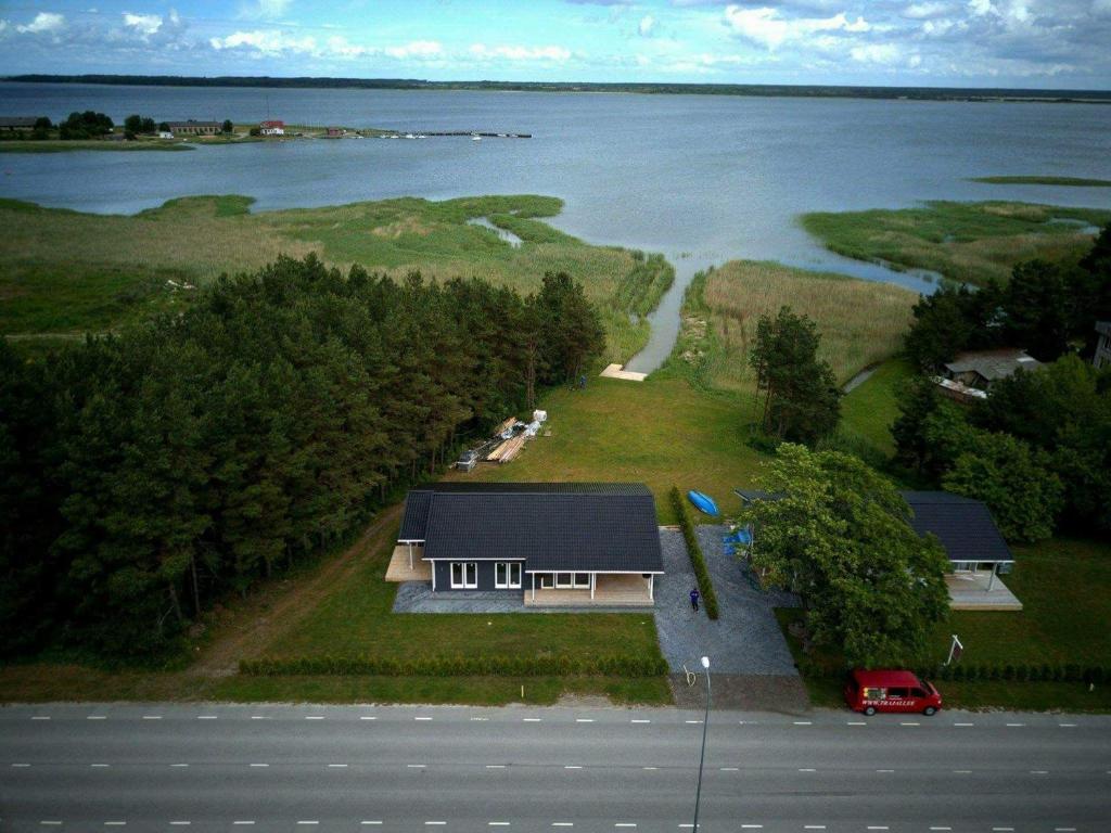 an aerial view of a house next to the water at Mereranna Puhkemajad in Orissaare