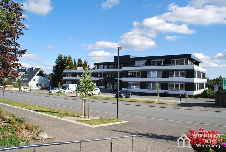 a large black building on the side of a street at Apartments Am Waltenberg 70 in Winterberg