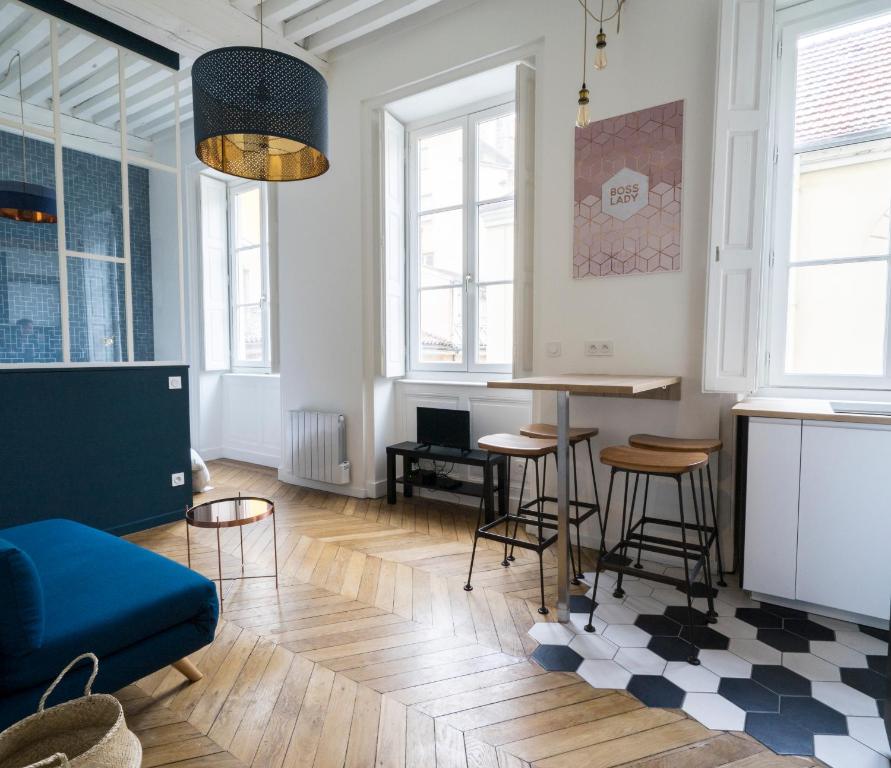 een woonkamer met een blauwe bank en een tafel bij Doyenné Vieux Lyon in Lyon