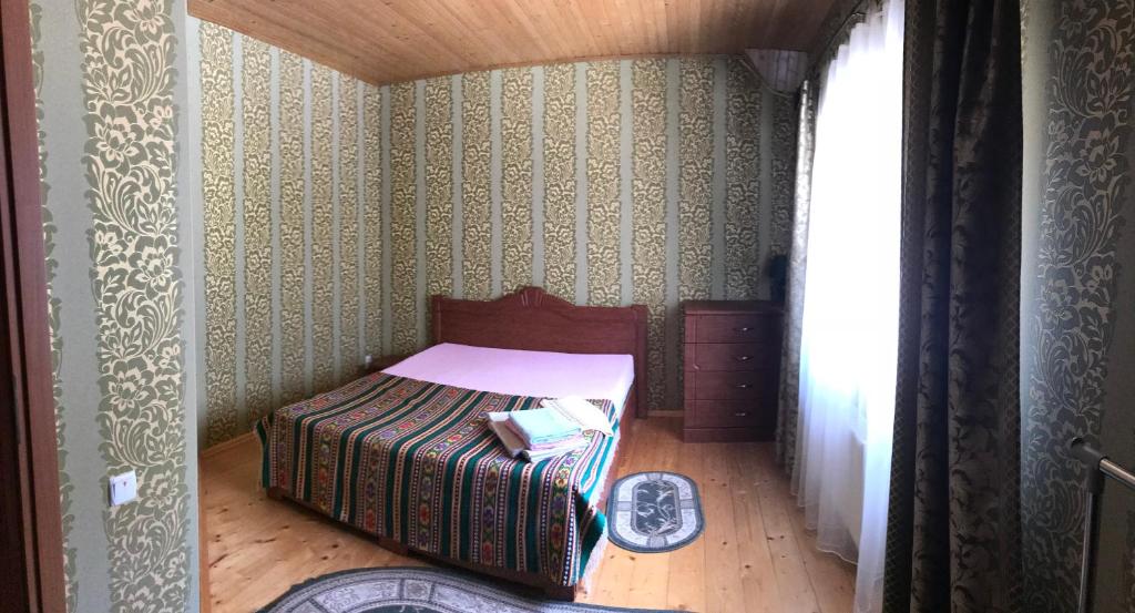 a small bedroom with a bed in a room at Котедж Relax Yaremche in Yaremche