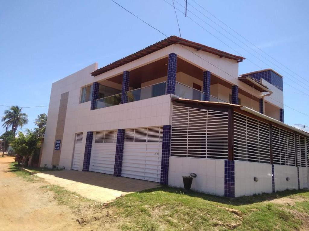 a large white building with a lot of windows at Pousada beira rio in Baía da Traição