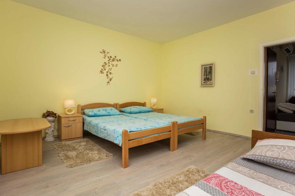a bedroom with a bed and a desk and a bed sidx sidx sidx at Apartment Ivica in Fažana