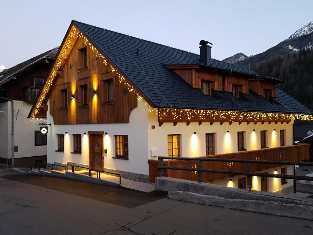 
a large white building with a large window at Hotel Vandot in Kranjska Gora
