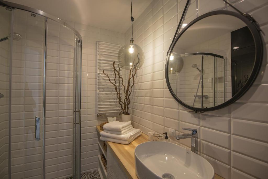 a bathroom with a sink and a mirror at ApartWisła in Wisła