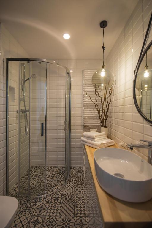 a bathroom with a shower and a sink and a tub at ApartWisła in Wisła