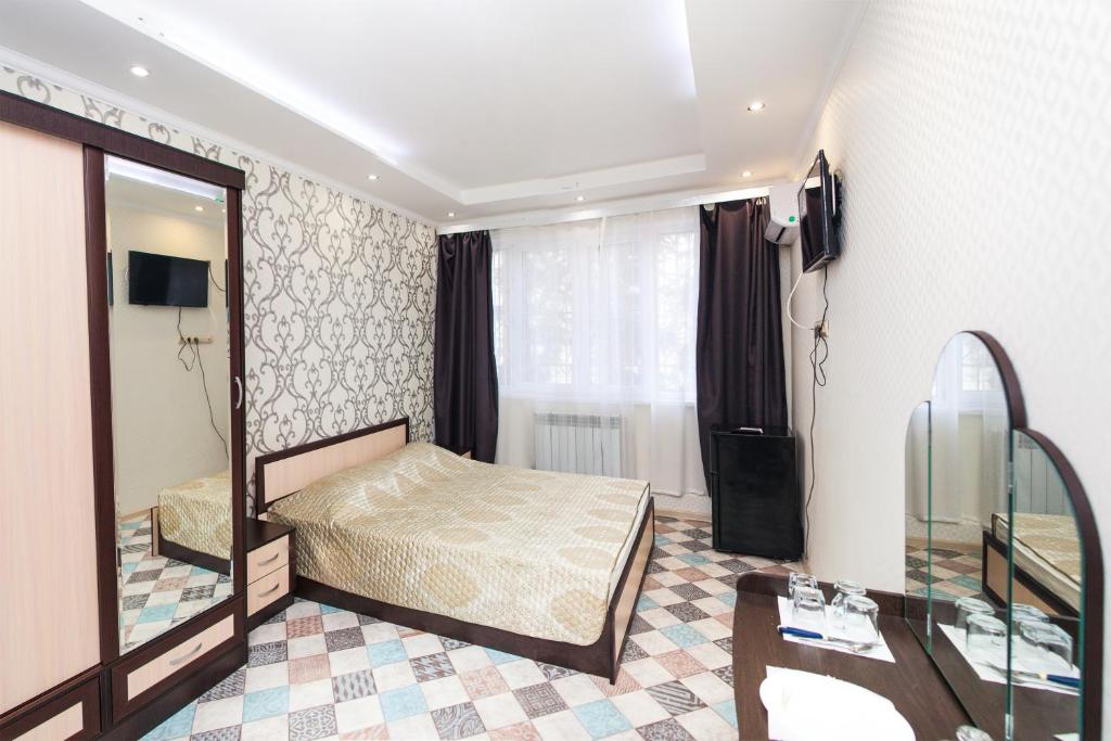Un ou plusieurs lits dans un hébergement de l'établissement Апартаменты на Параллельной 8-6