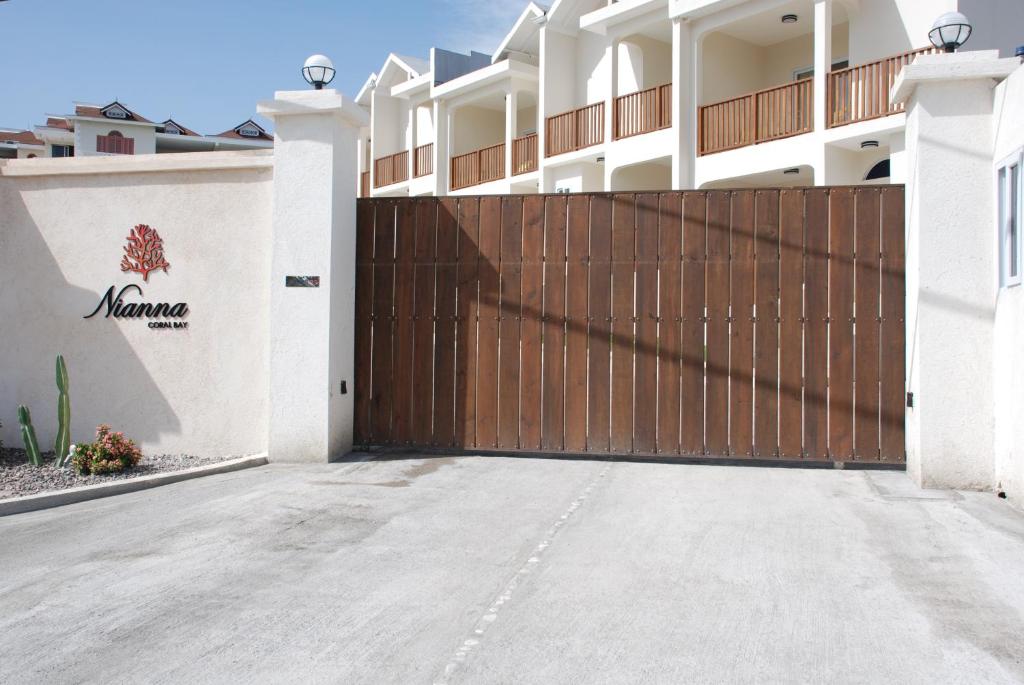 a driveway in front of a house with a wooden gate at Family Complex beside Beach w/Pool Montego Bay #2 in Montego Bay