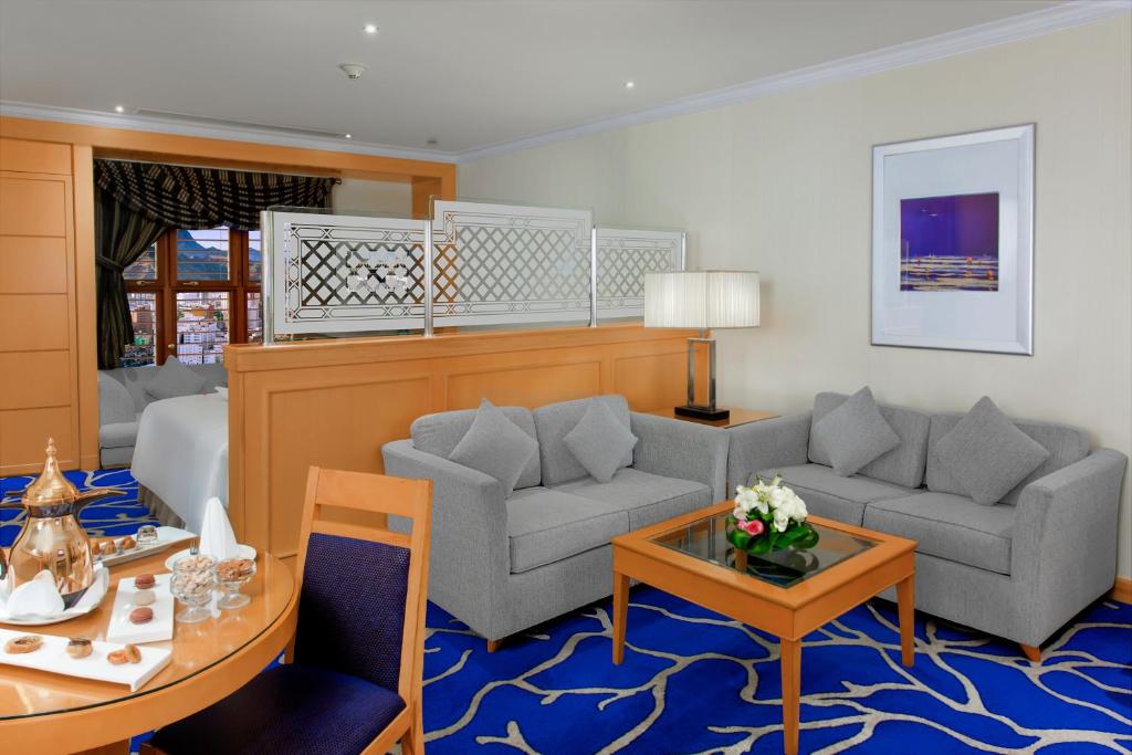 a living room with two couches and a table at Makkah Towers in Mecca