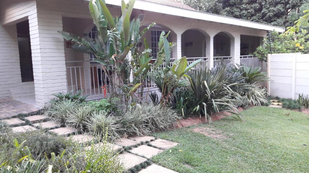 a garden in front of a house with plants at JS Inn in Nelspruit