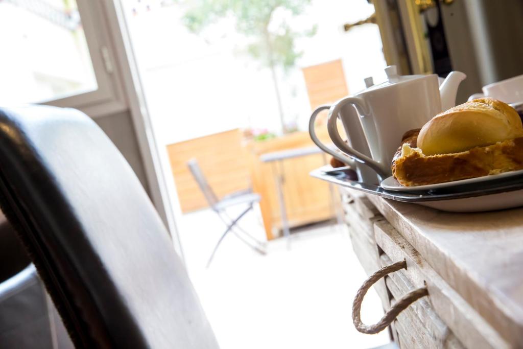 a plate of food on a counter with a sandwich at Almoria Hôtel & SPA in Deauville