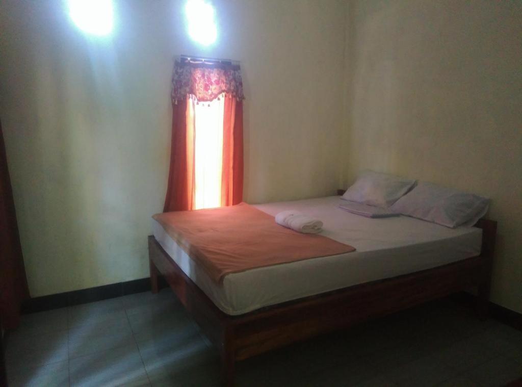 Postel nebo postele na pokoji v ubytování Pedek Homestay