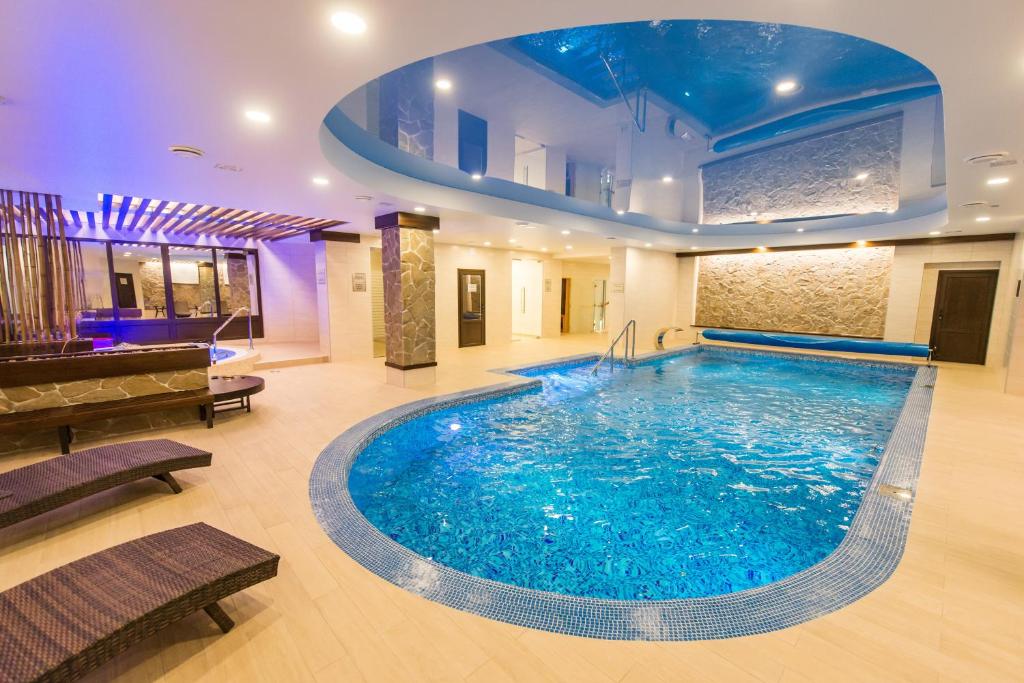 a large swimming pool in a large room at Orion Hotel in Vladimir