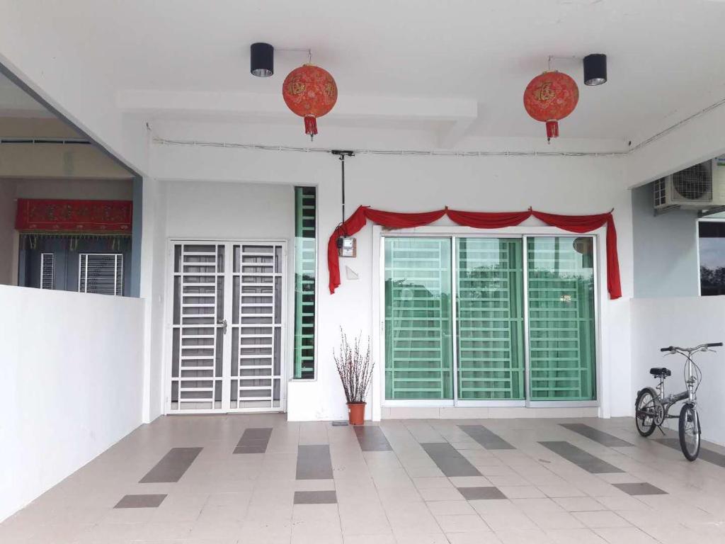 a room with a large door with a red curtain at OOI Homestay Alor Setar in Alor Setar