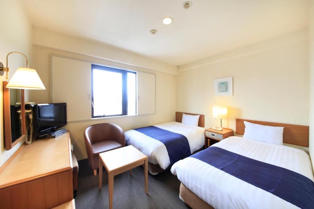 Postel nebo postele na pokoji v ubytování Shonandai Daiichi Hotel Fujisawa Yokohama