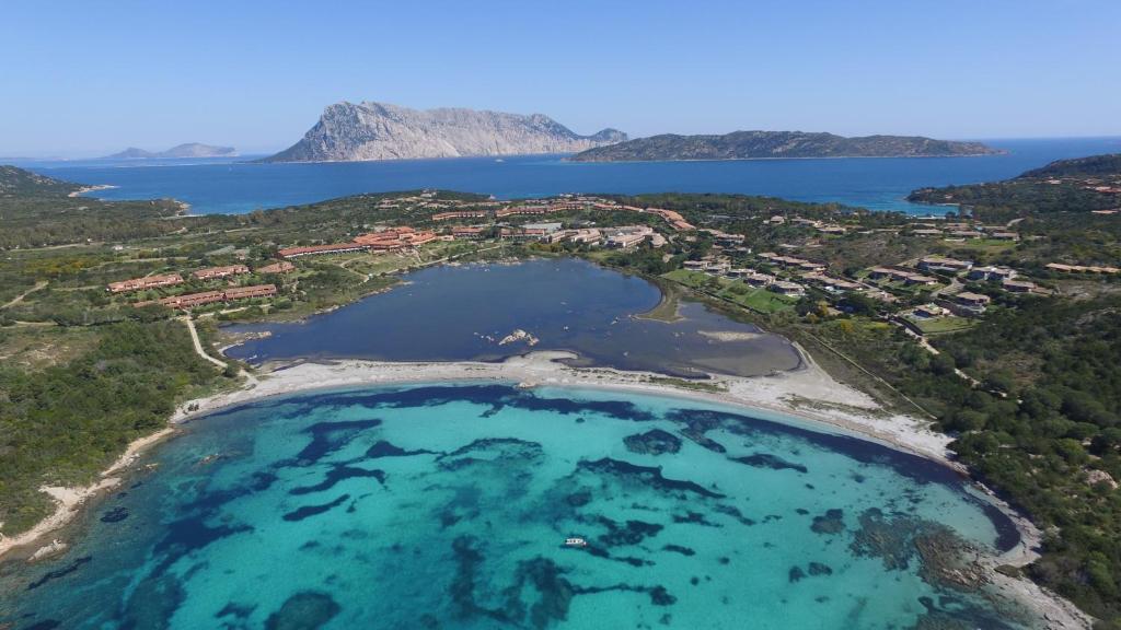 an aerial view of a beach with turquoise water at Residence Porto Coda Cavallo in San Teodoro