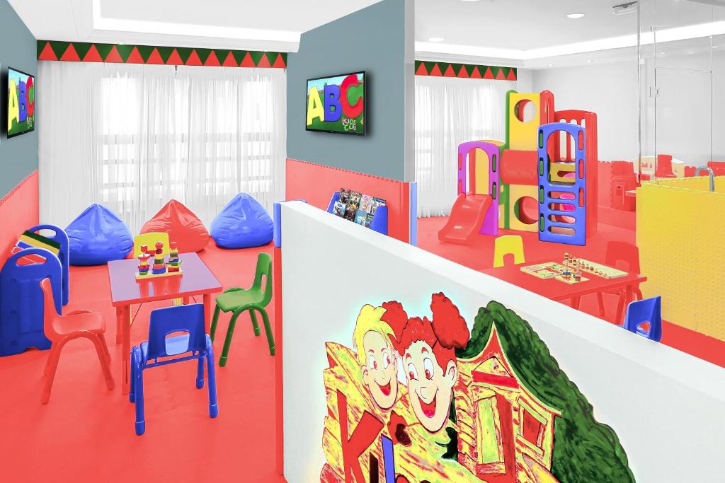 a childrens play room with a table and chairs at Makkah Towers in Mecca