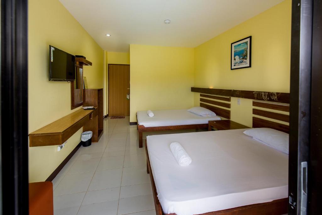 Postel nebo postele na pokoji v ubytování Greenfields Tourist Inn