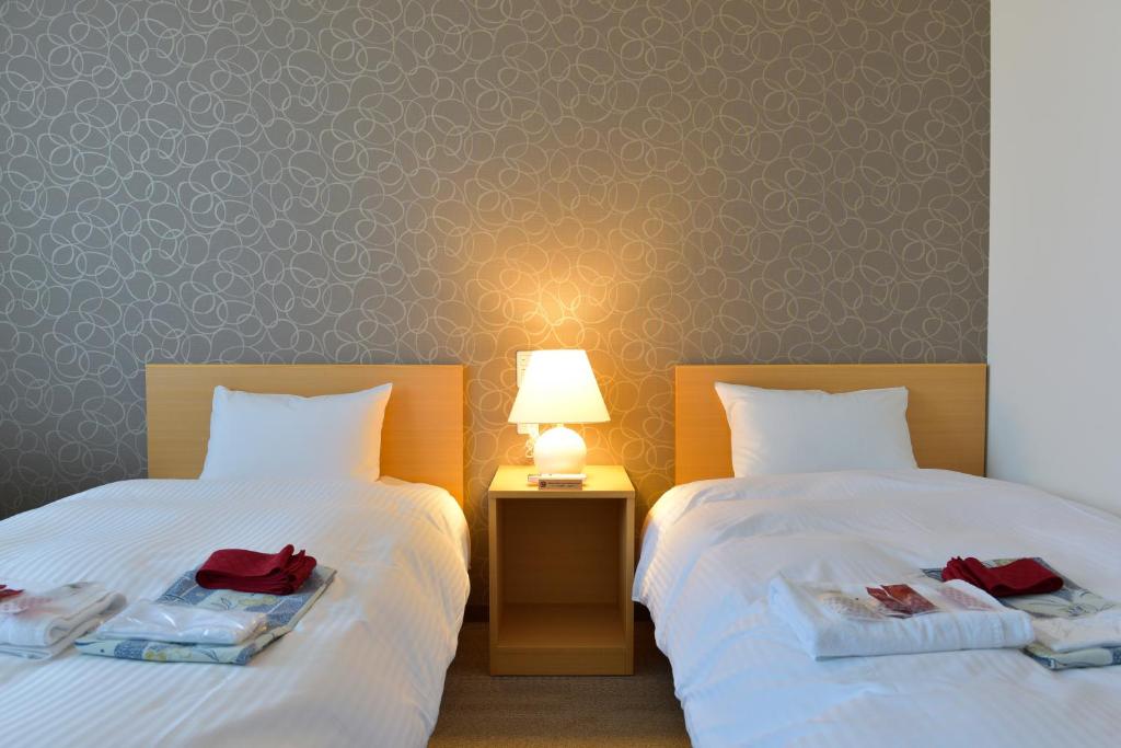 Postel nebo postele na pokoji v ubytování Sun Plaza Hotel Fuji Lake Yamanaka