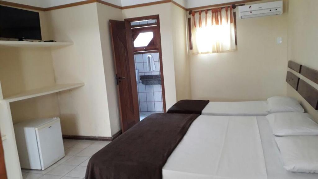 Postel nebo postele na pokoji v ubytování Coroa Bella Praia Hotel